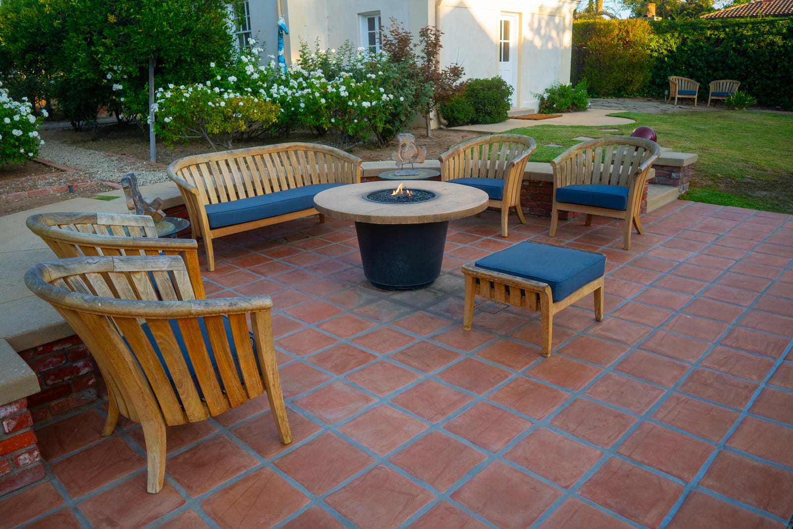 Spanish Estate terracotta patio with fire pit table and seating