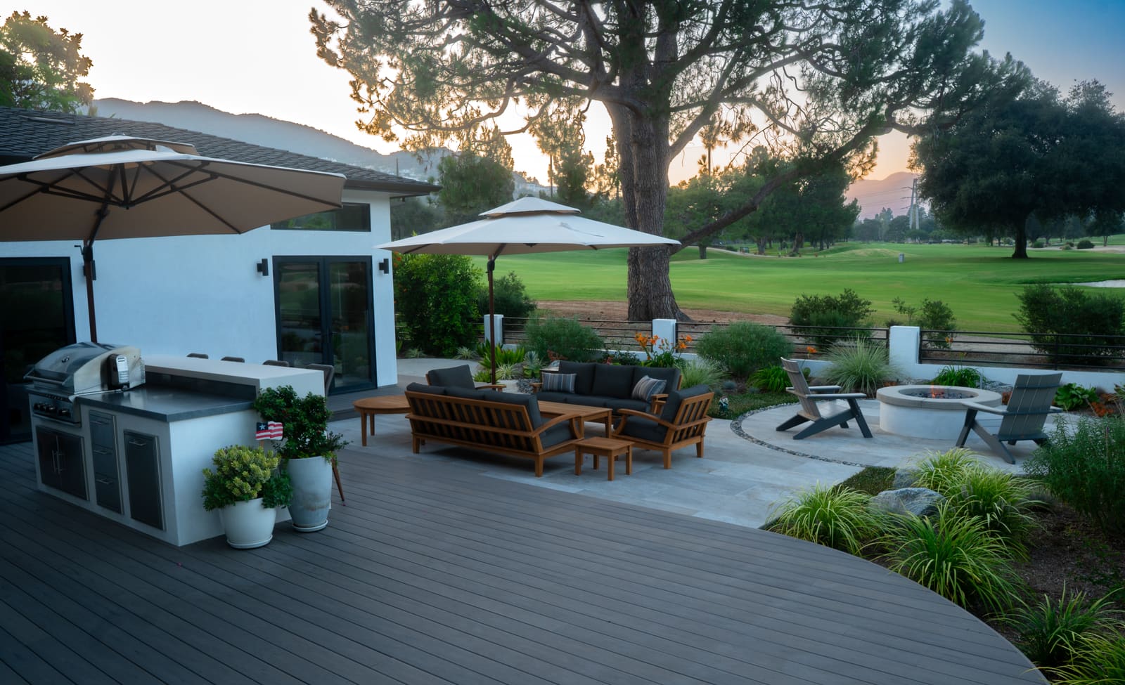 Teak seating and dining on the composite deck, looking out over the fairway