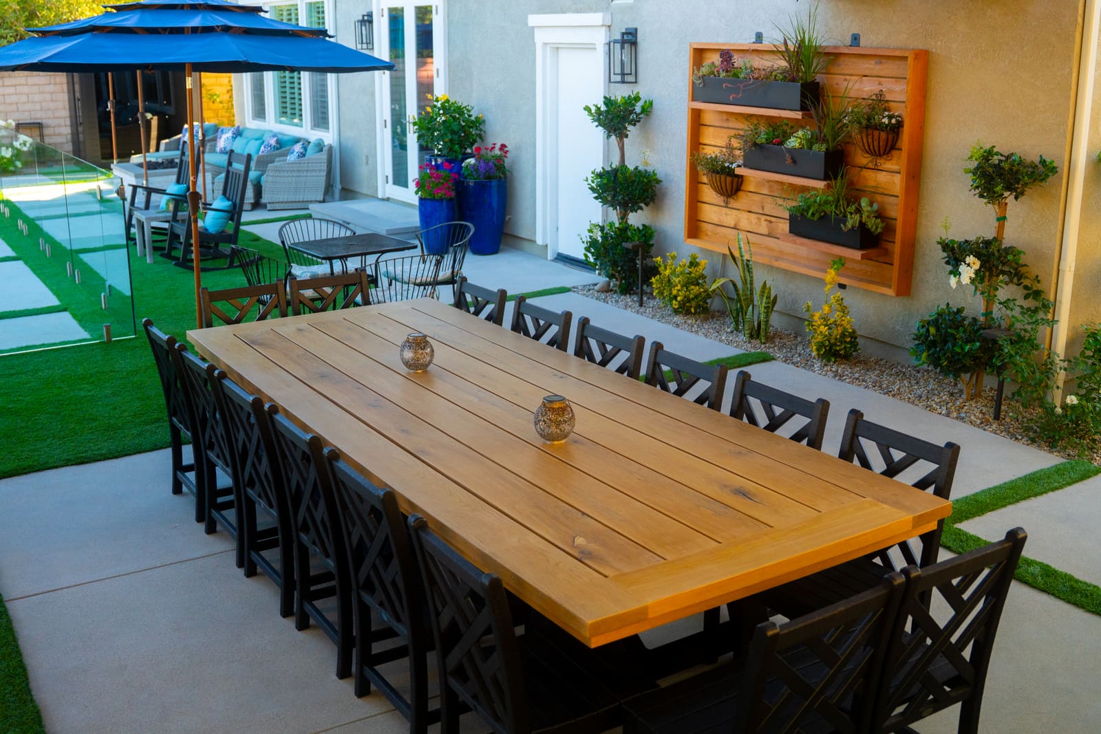 Timber slat wall planted with herbs and trailing greenery above the dining terrace