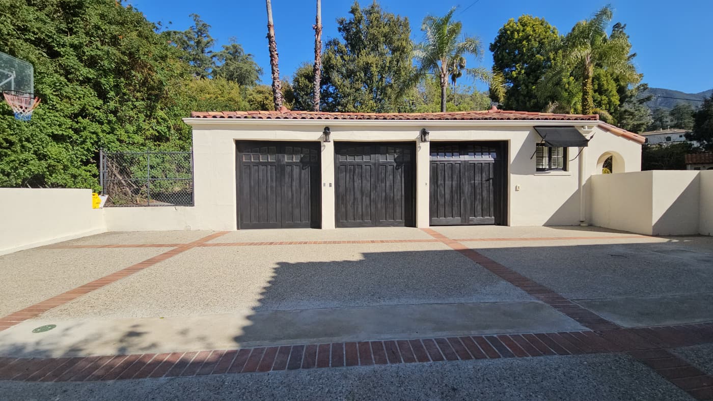 The garage apron before construction, in aggregate concrete banded with red brick