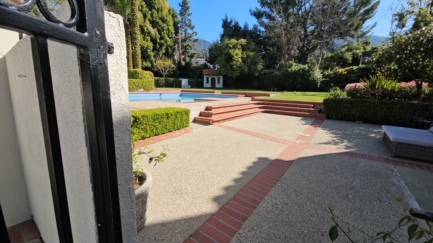 The pool terrace before construction, in aggregate paving with red brick banding and red-painted steps