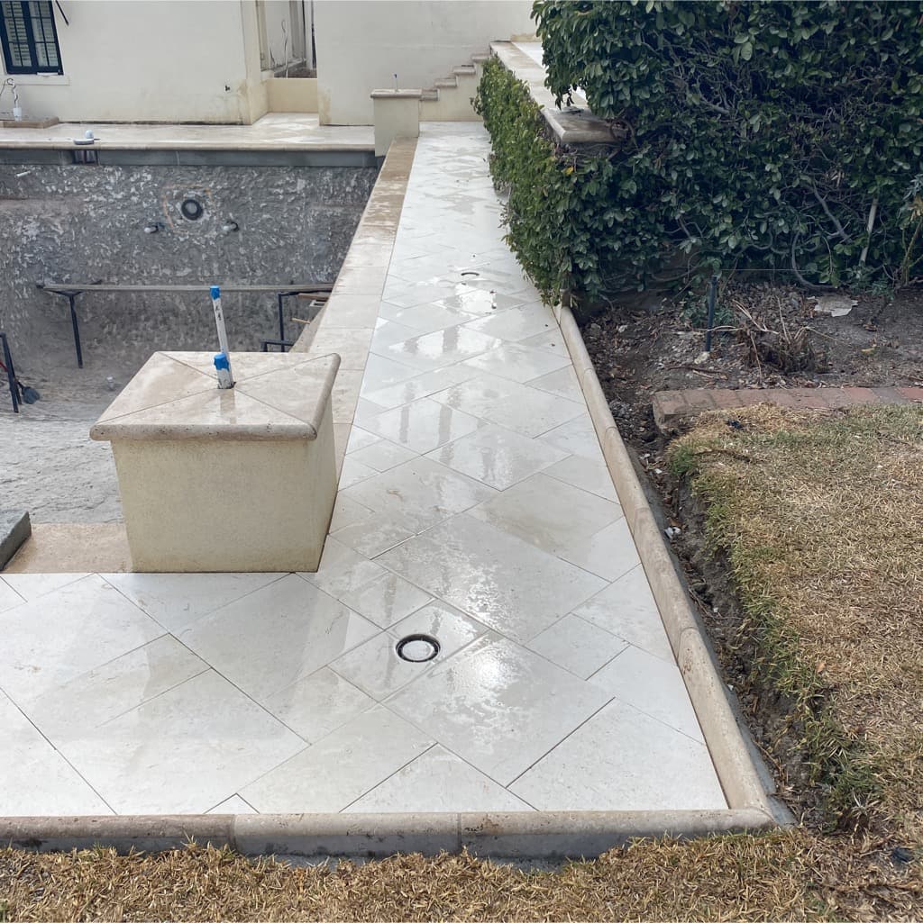 The pool surround stripped back during construction, before the new stone deck was laid