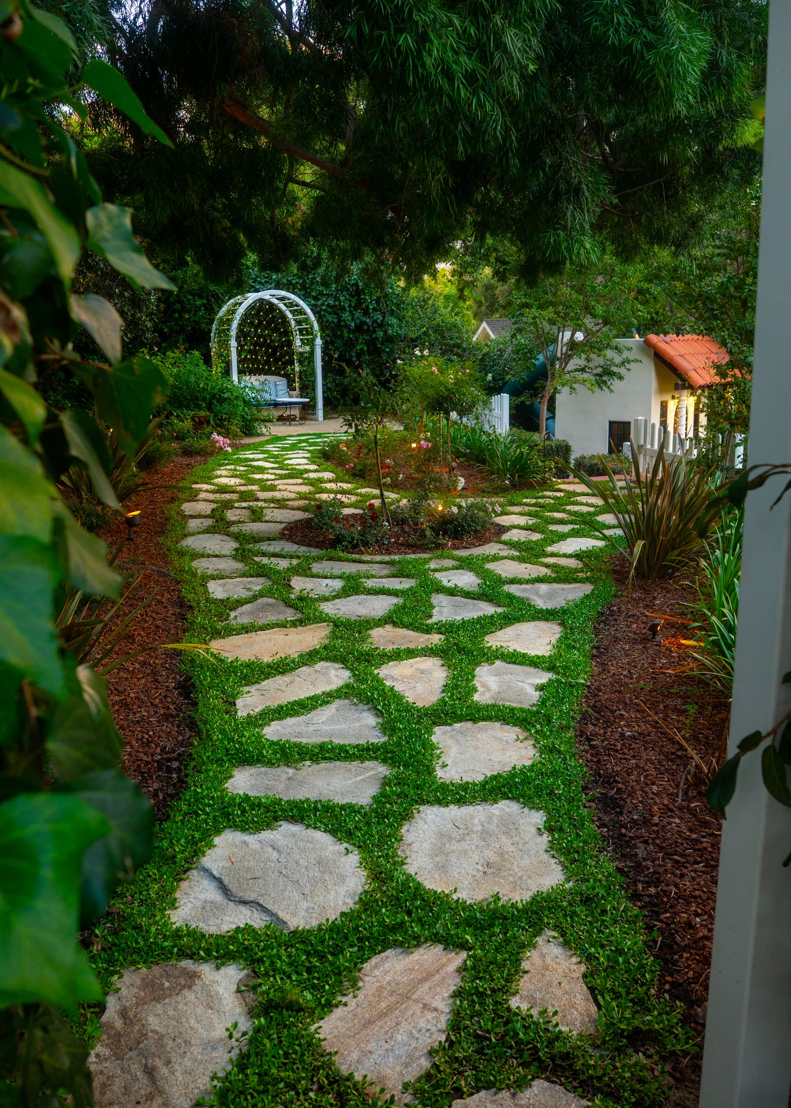 Sydney Peak flagstone path with wide joints planted with kurapia groundcover, running between planting beds
