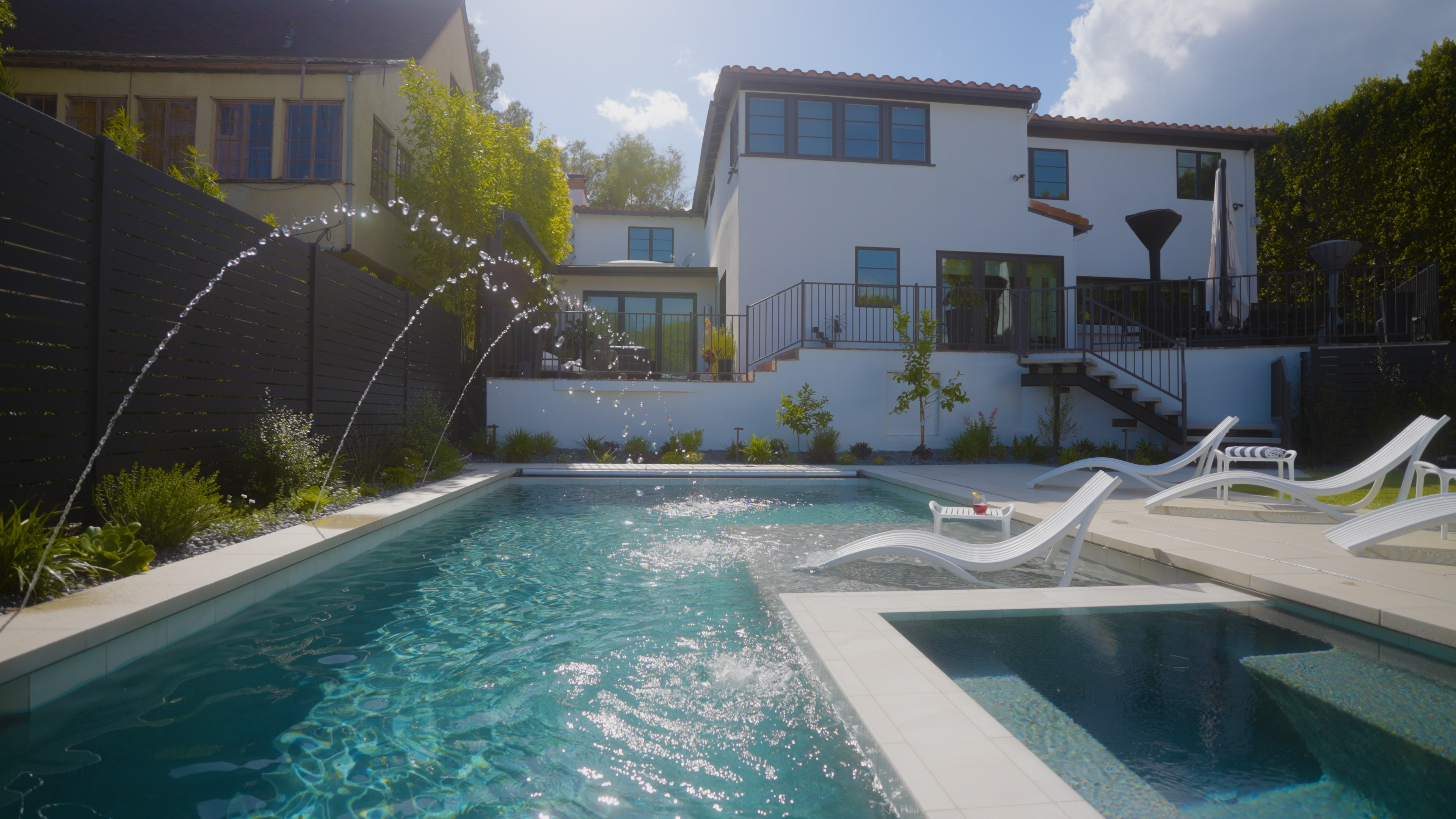 Remodeled pool with updated finishes, new deck, and landscaping