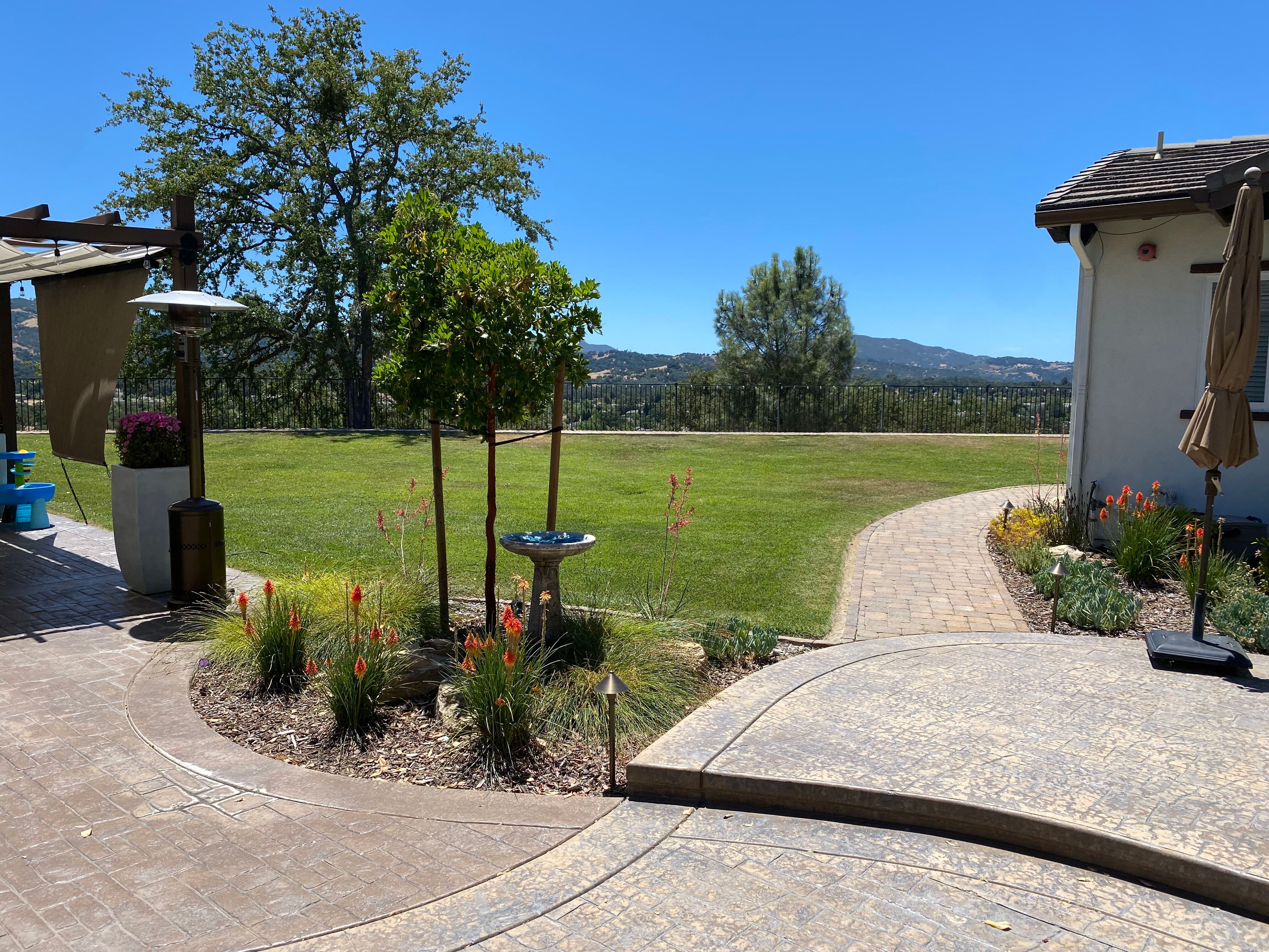 A residential property backyard before pool construction begins, showing the existing conditions for site analysis