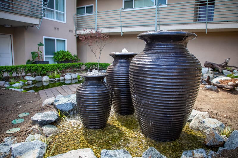 A garden fountain and pond feature framed by mature planting