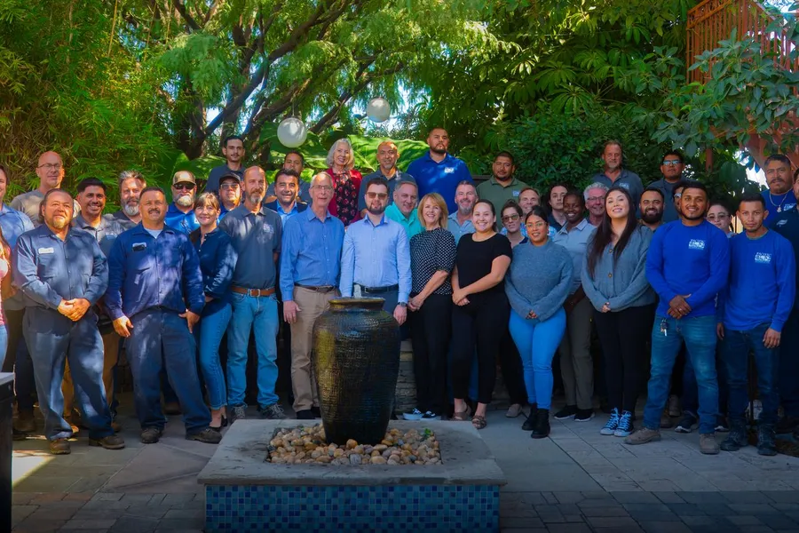 The Pacific Outdoor Living team photographed together in the courtyard at their offices