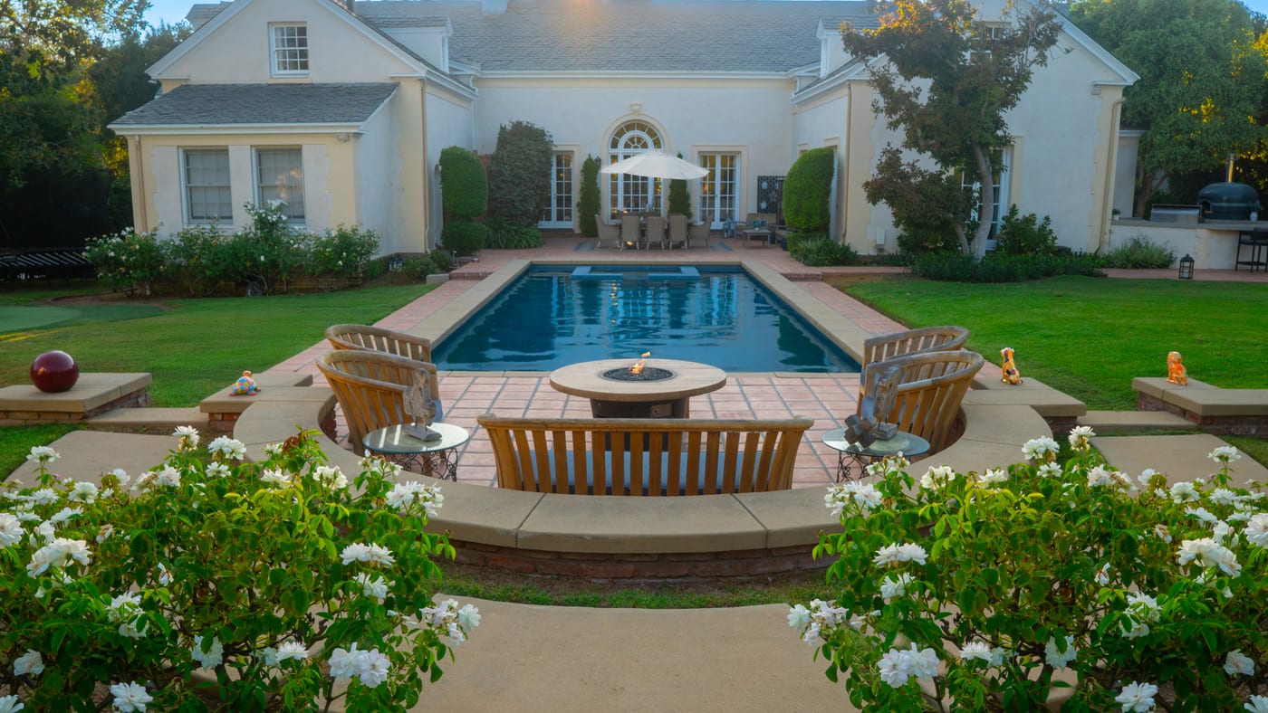 A Mediterranean-style outdoor space with warm paving, architectural planting and layered garden details