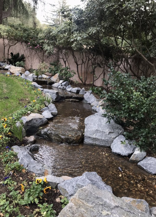 The finished running creek built along a narrow side yard