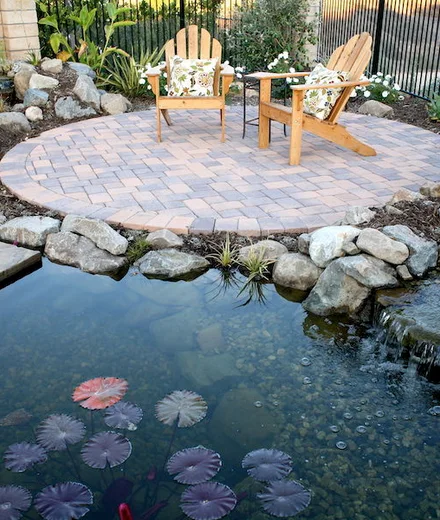 Koi pond and paver seating circle by Pacific Outdoor Living