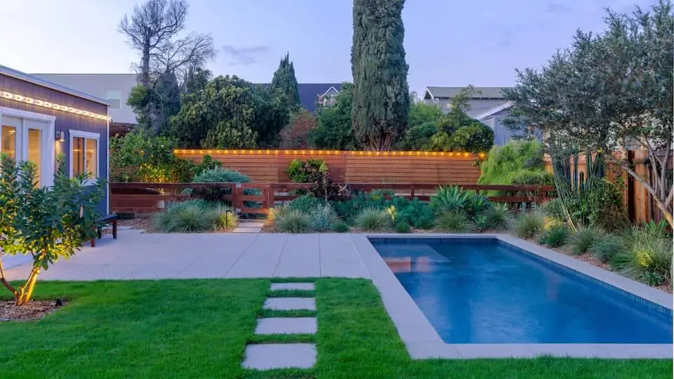Small Los Angeles backyard with inground pool, stone walkway, and modern landscaping
