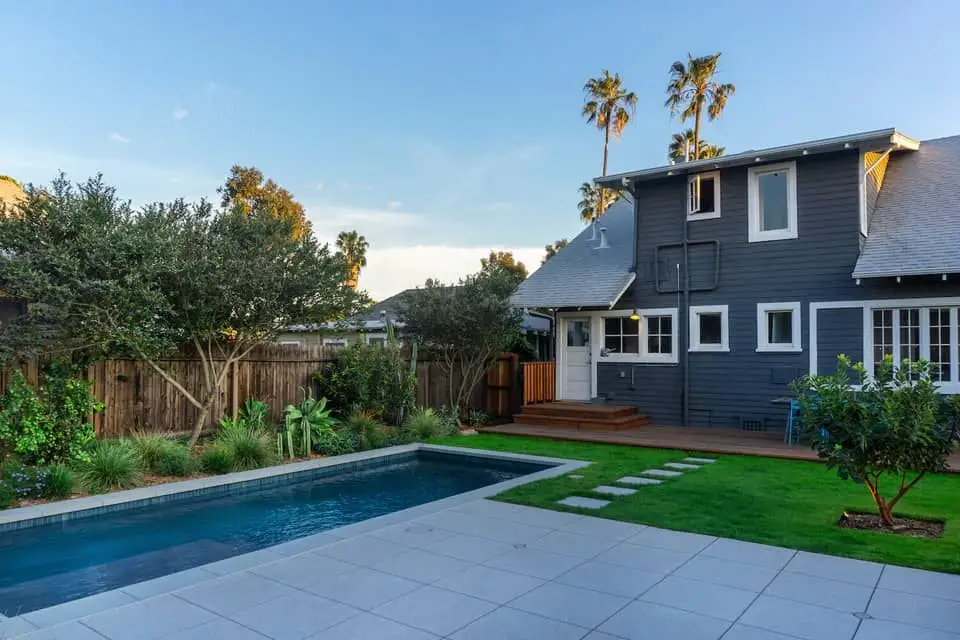 Los Angeles Home and backyard with inground pool, fence, walkway, grass, and plants