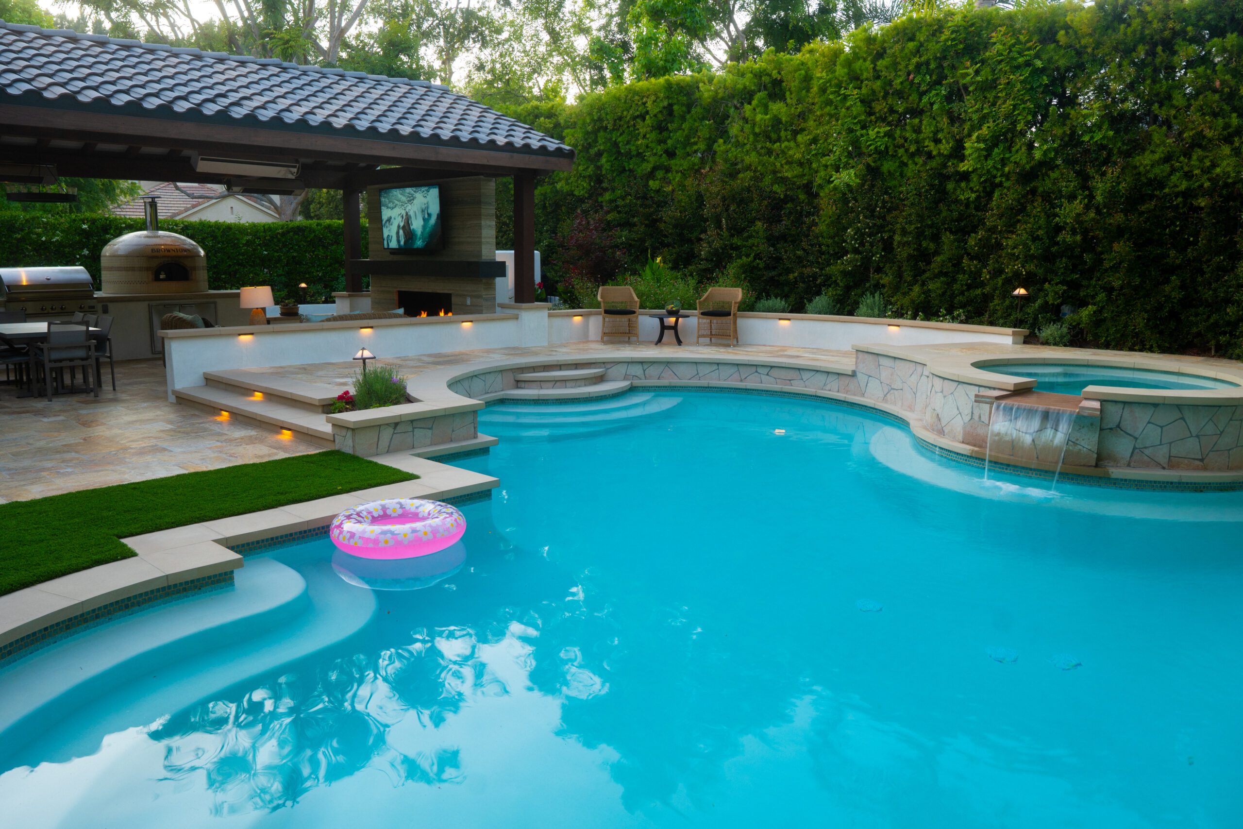 Completed backyard with pool and outdoor kitchen designed and built by Pacific Outdoor Living