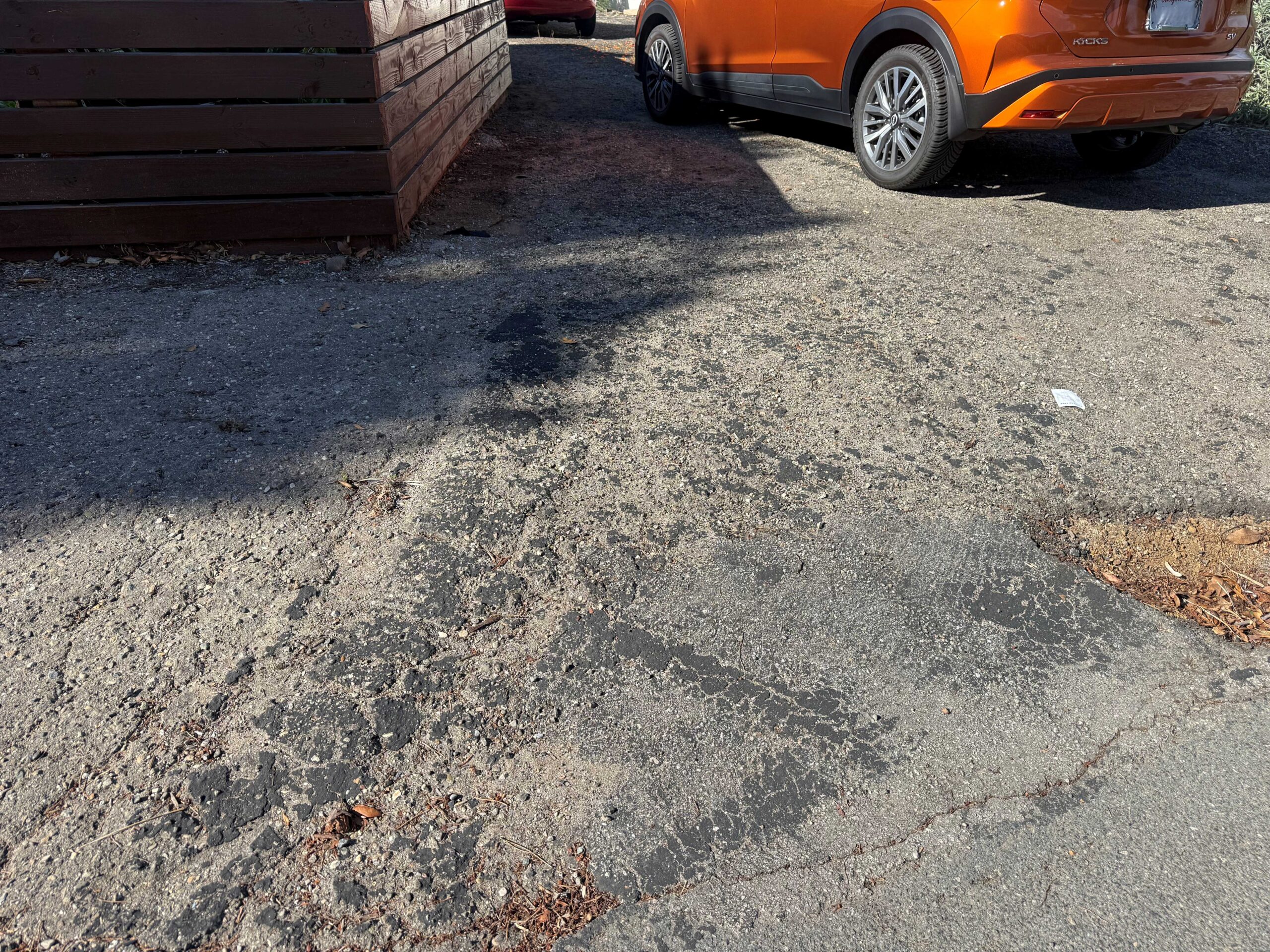 Cracked, deteriorating driveway surface prior to design and construction by Pacific Outdoor Living