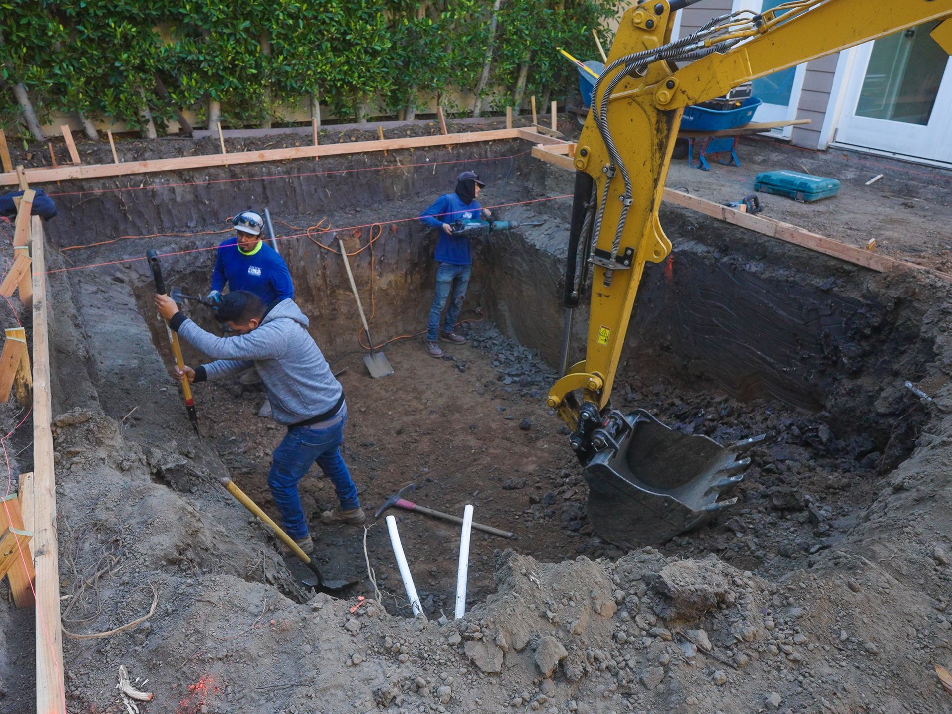 In-house crew performing excavation and grading work on property