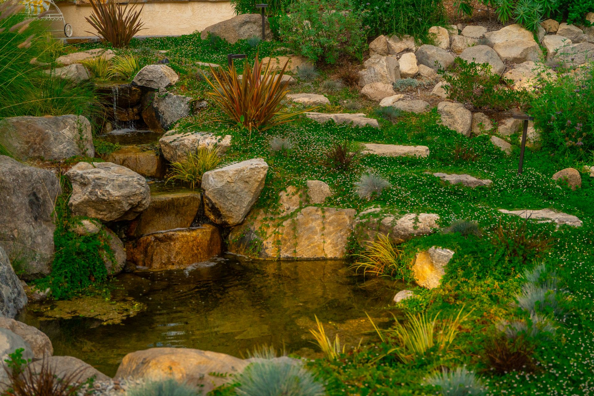 Natural landscape with rock features, water elements, and native plantings