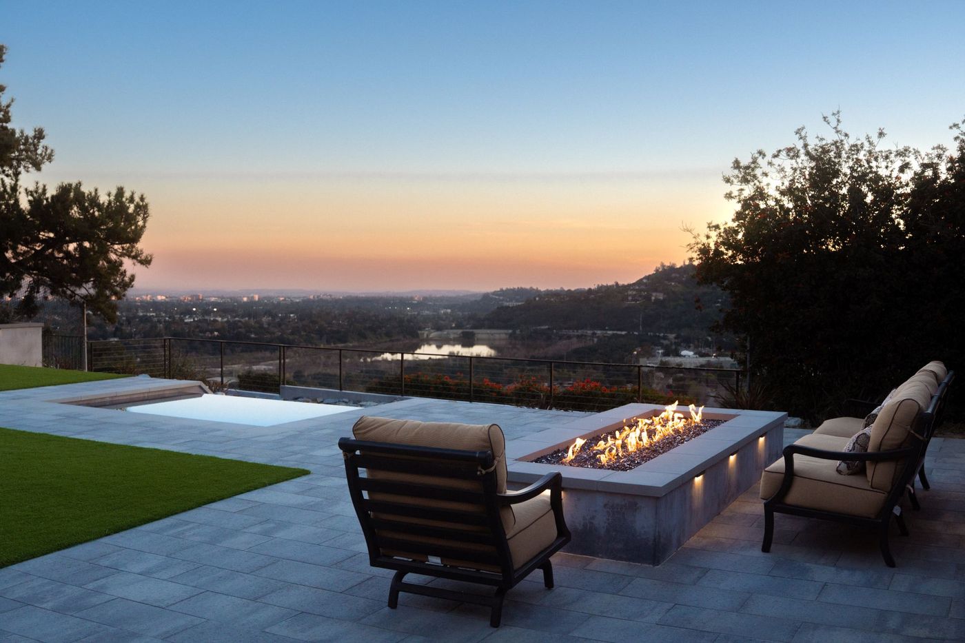 Hillside backyard fire pit with evening views