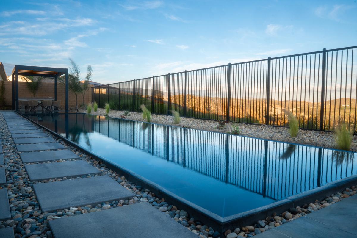 Modern water feature with fire-safe hardscape and defensible-space planting