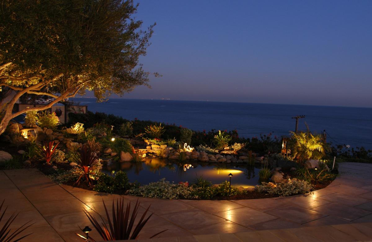 Evening landscape lighting design with water feature and ambient accent lighting