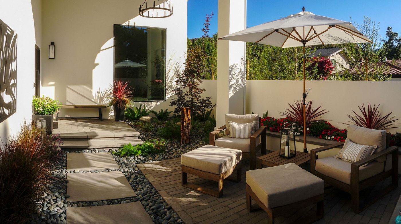Low-maintenance patio with durable plantings and hardscape