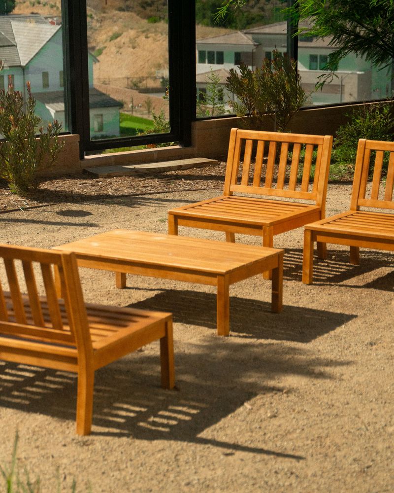 Courtyard seating with wood bench, decomposed granite, and drought-tolerant planting