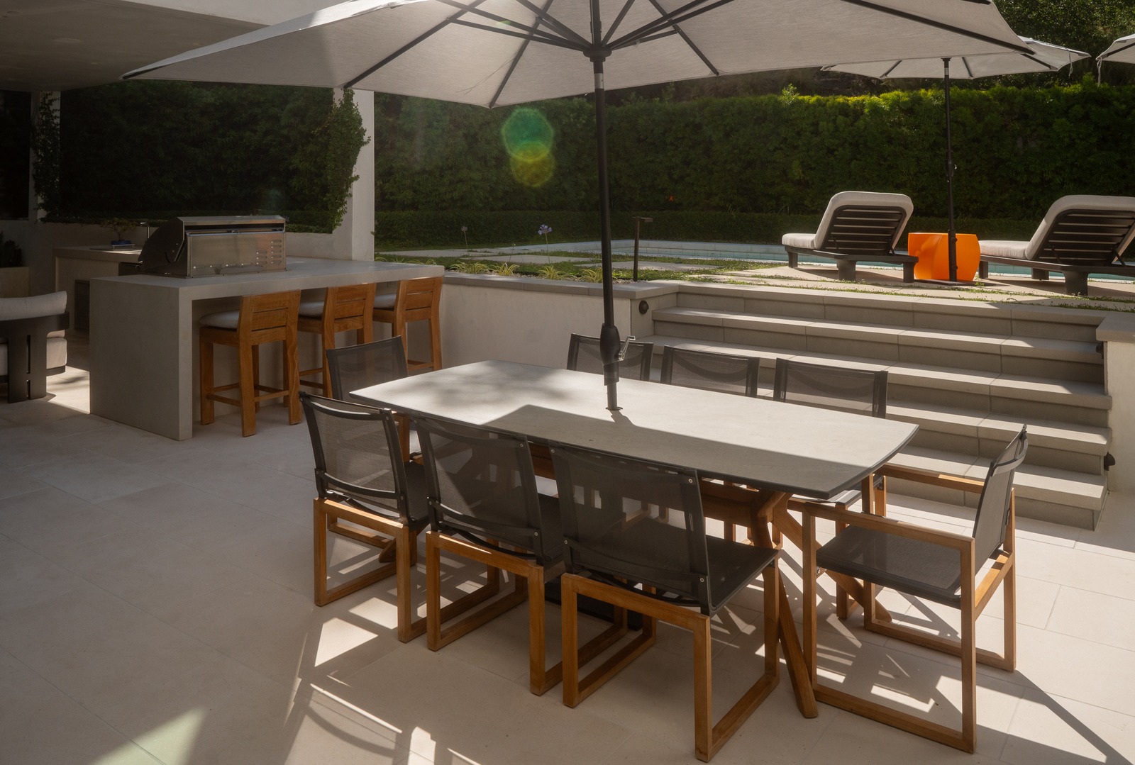 Backyard pool and spa with modern hardscape and pergola shade structure