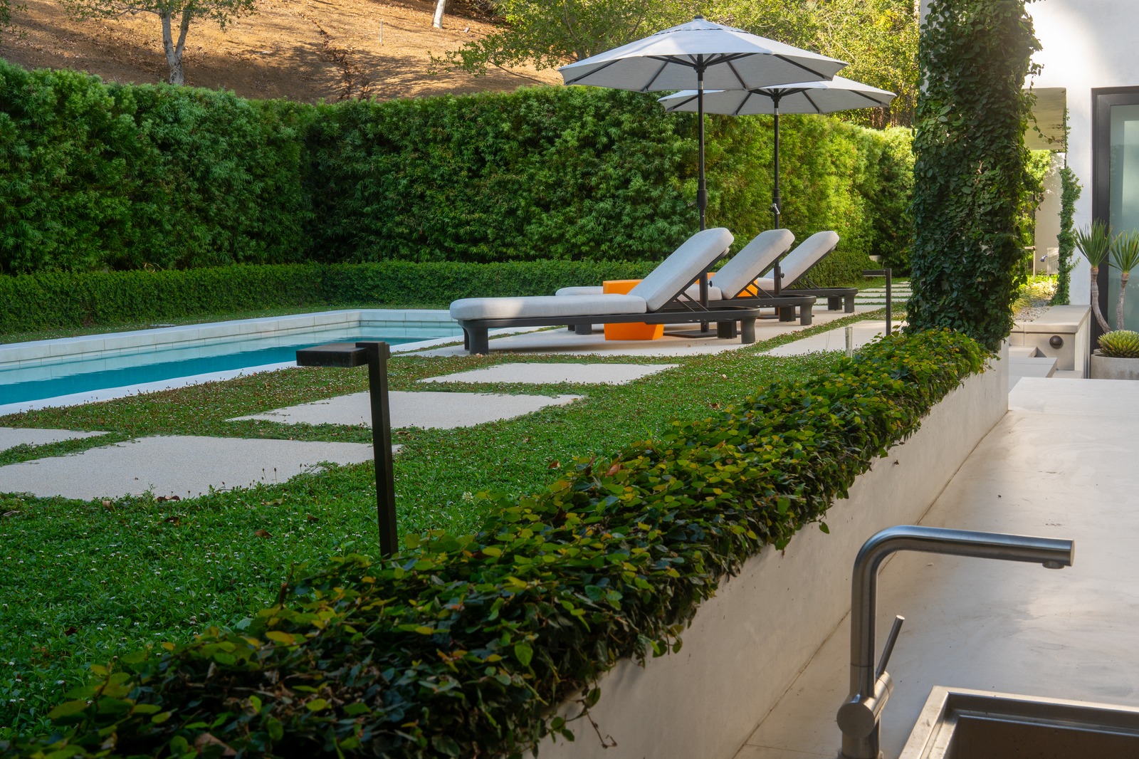 Pergola shade structure with outdoor lounge seating area