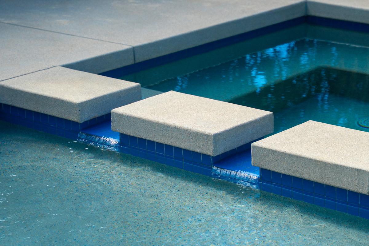 Modern patio and pool area with sophisticated landscaping