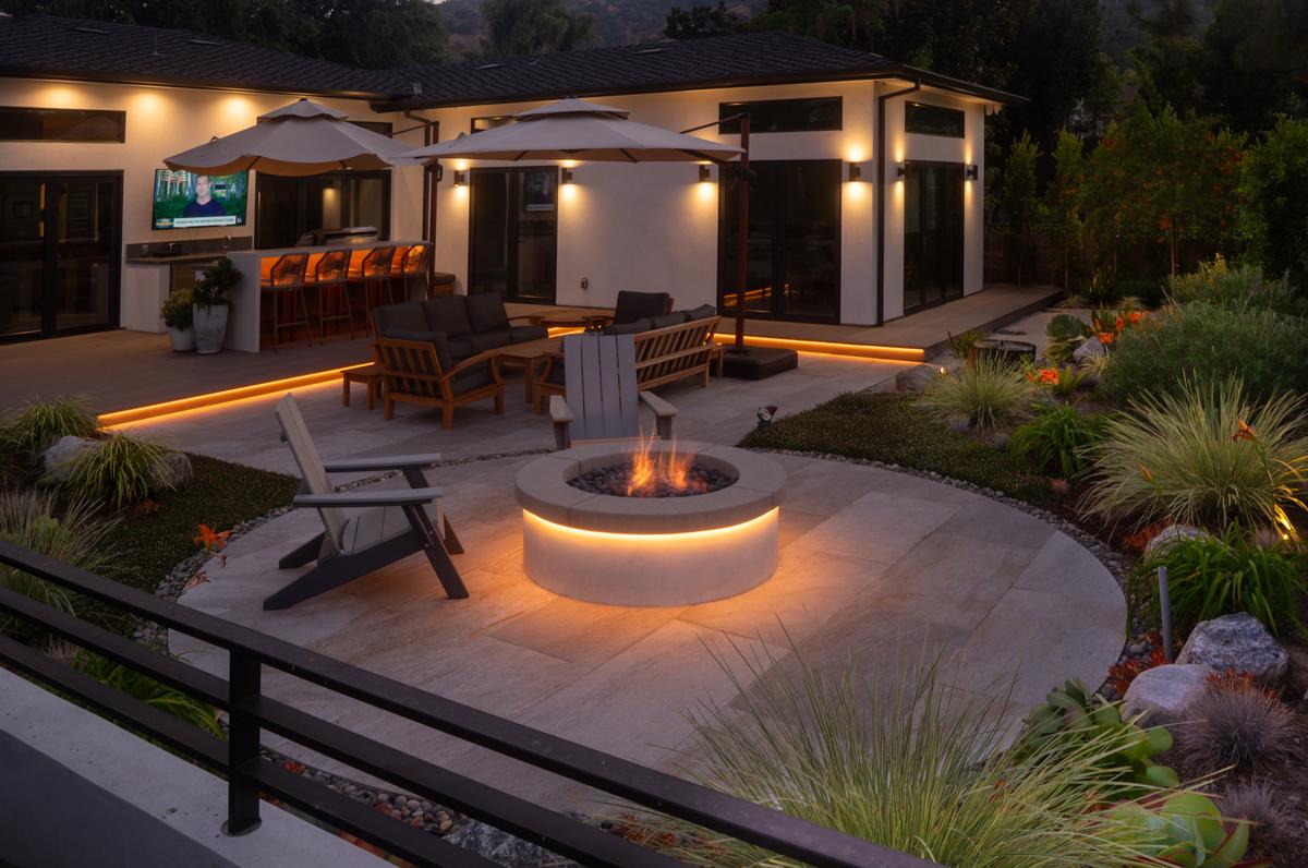 Sophisticated water-wise entertainment space with landscape lighting and drought-tolerant planting