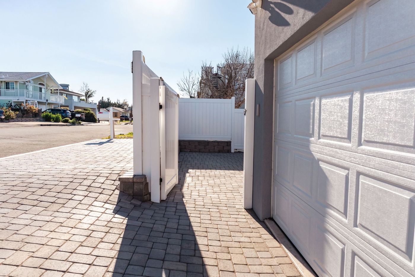 Custom paver driveway installation in Morro Bay leading to a residential garage with clean concrete edging.