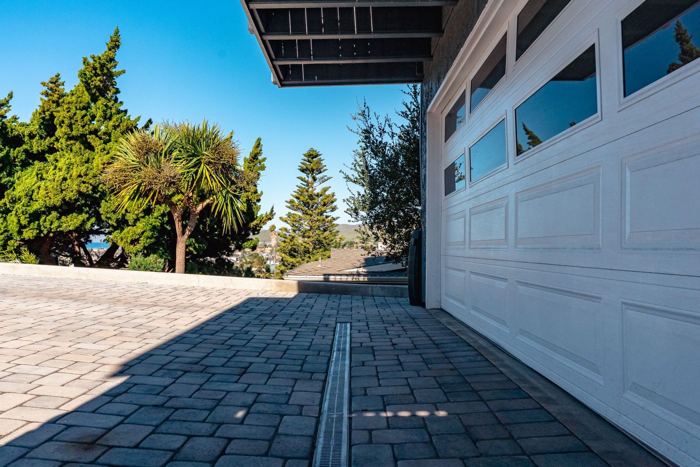 Linear drainage channel installed within a sloped paver driveway in Morro Bay, California.