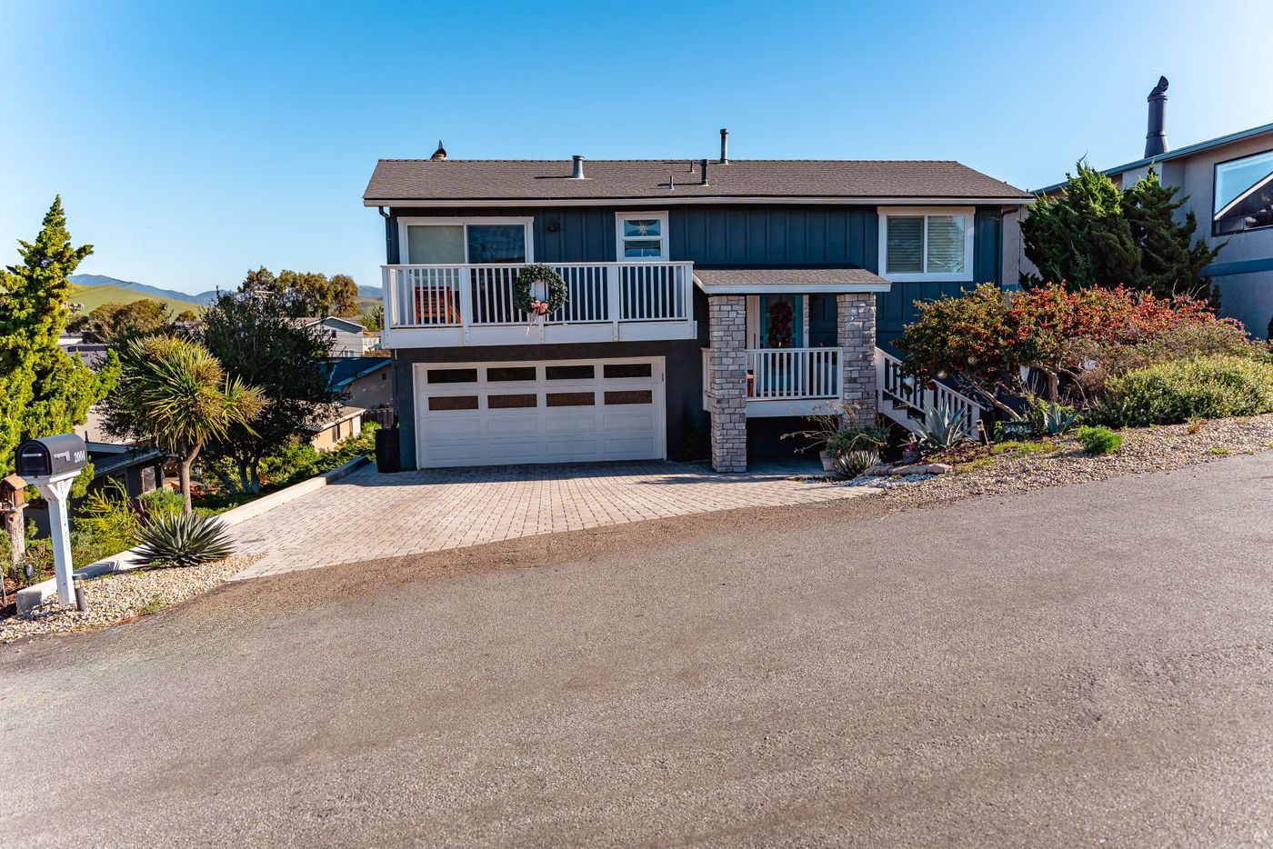Wide street-level view of custom interlocking paver driveway installation in Morro Bay, California.