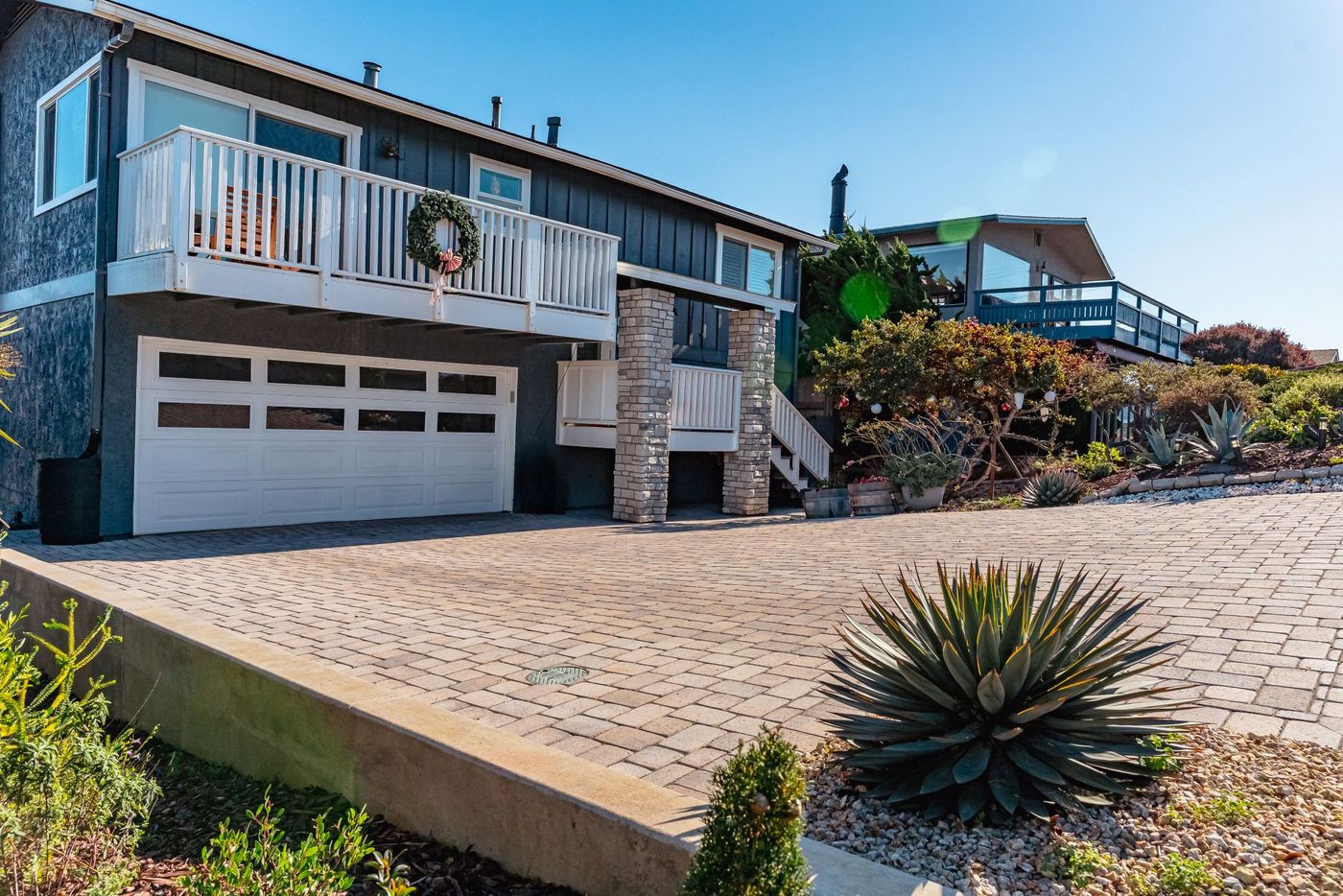 Concrete curb and edge detail alongside a custom paver driveway installation in Morro Bay.
