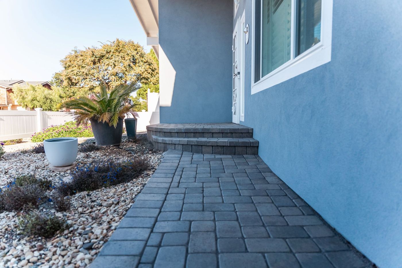 Front entry steps constructed with interlocking concrete pavers as part of a Morro Bay driveway installation.