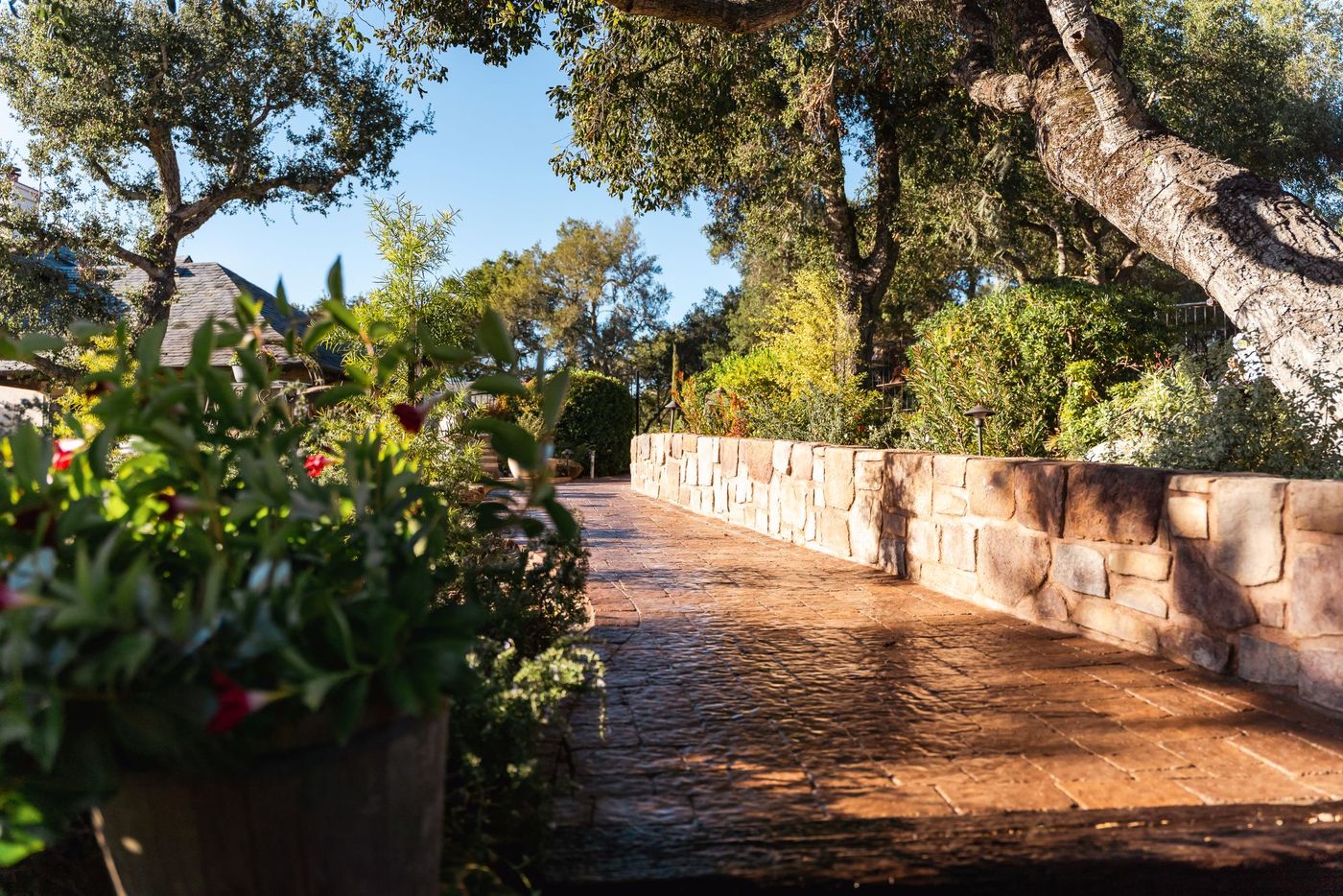 Detailed view of stamped concrete paver walkway bordered by a stone retaining wall in Paso Robles.