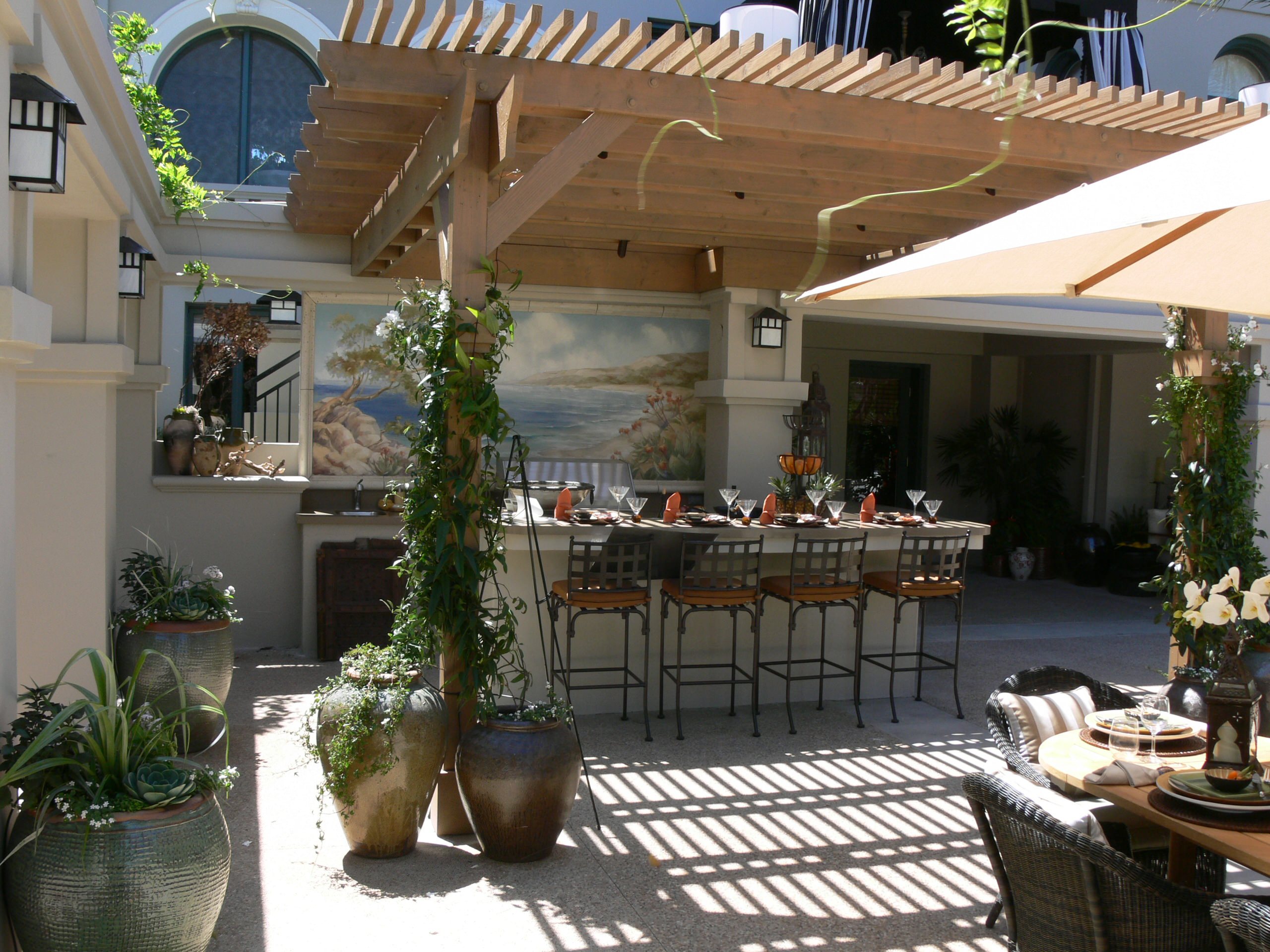 A white aluminum pergola with an open roof over a patio