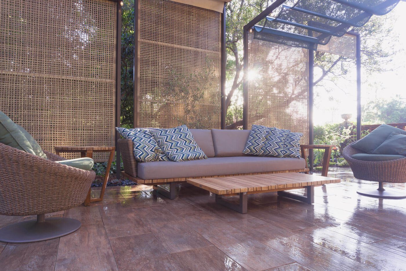 A lattice pergola outdoor room with comfortable seating, lounge chairs, and contemporary furnishings for entertaining