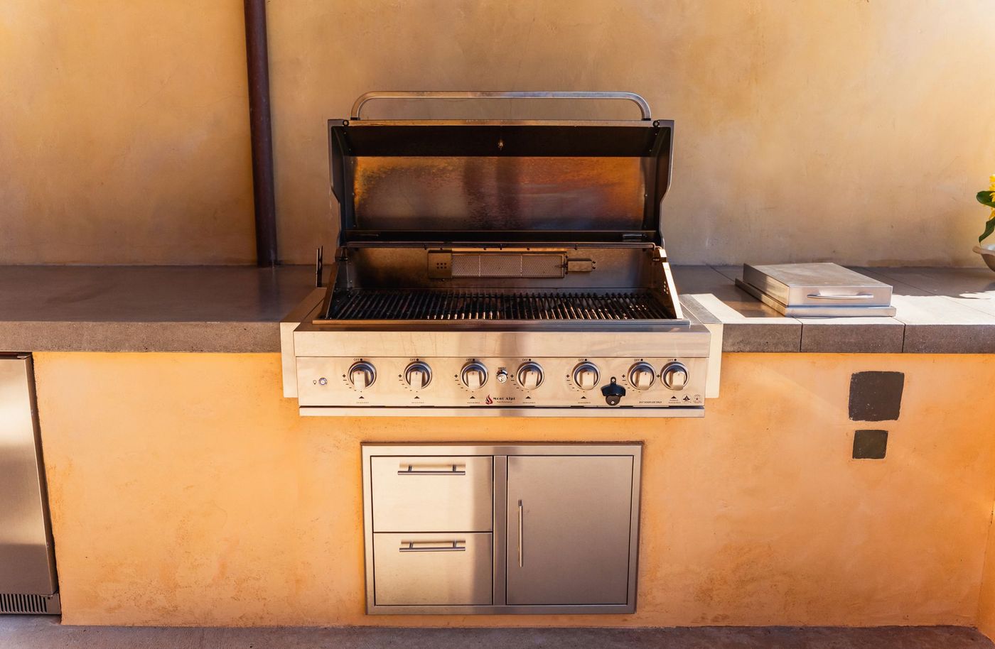 Close-up of custom BBQ island grill with stainless steel finish in a San Luis Obispo outdoor kitchen.