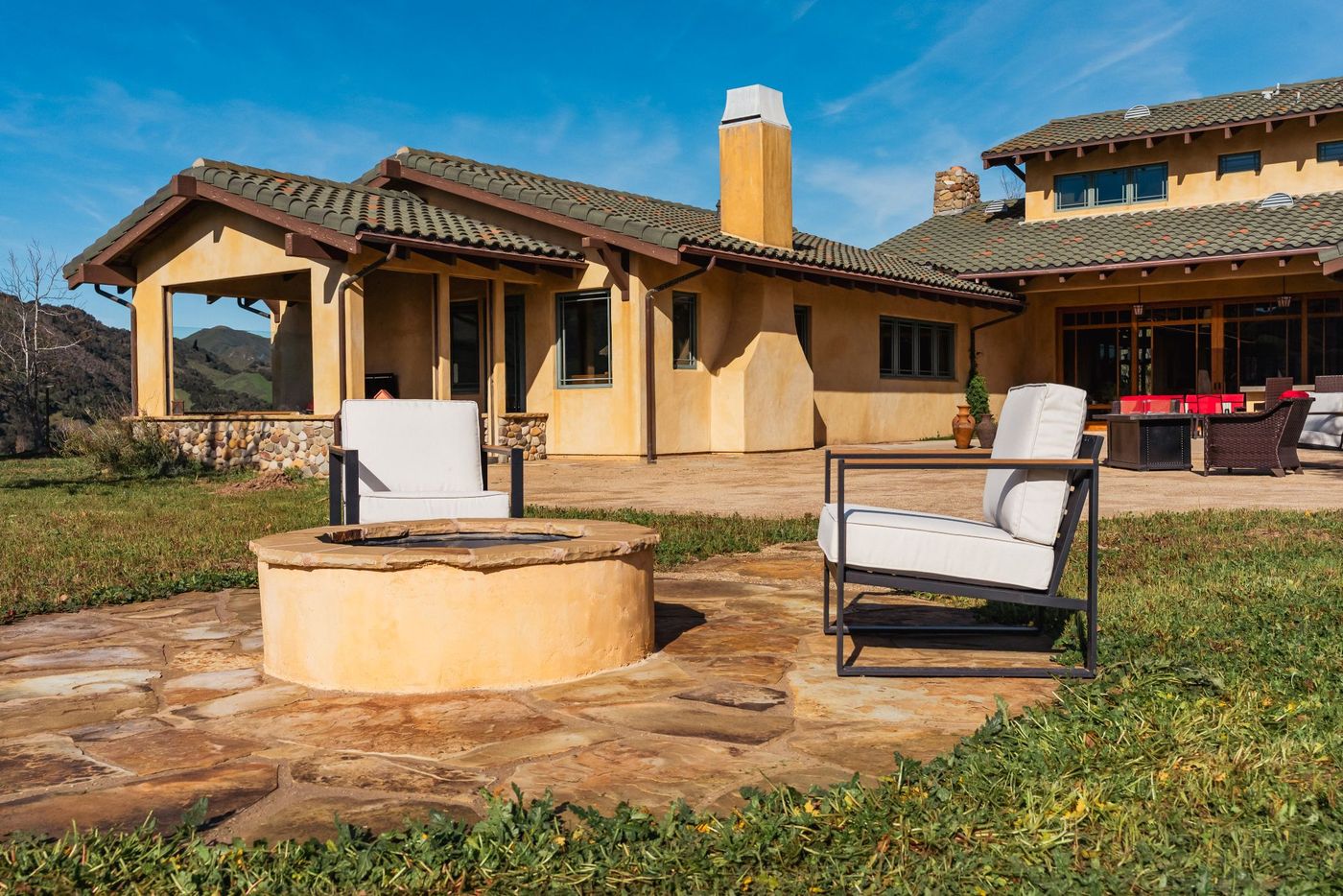 Circular stone fire pit installed in a San Luis Obispo backyard outdoor living space.