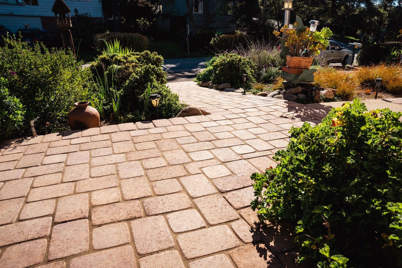 Custom paver walkway installation in San Luis Obispo featuring interlocking pavers and landscaped planting beds.