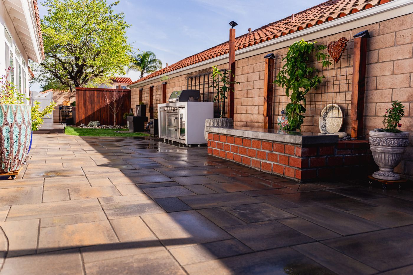 Built-in outdoor kitchen with grill and storage installed on a custom paver patio in Santa Maria.