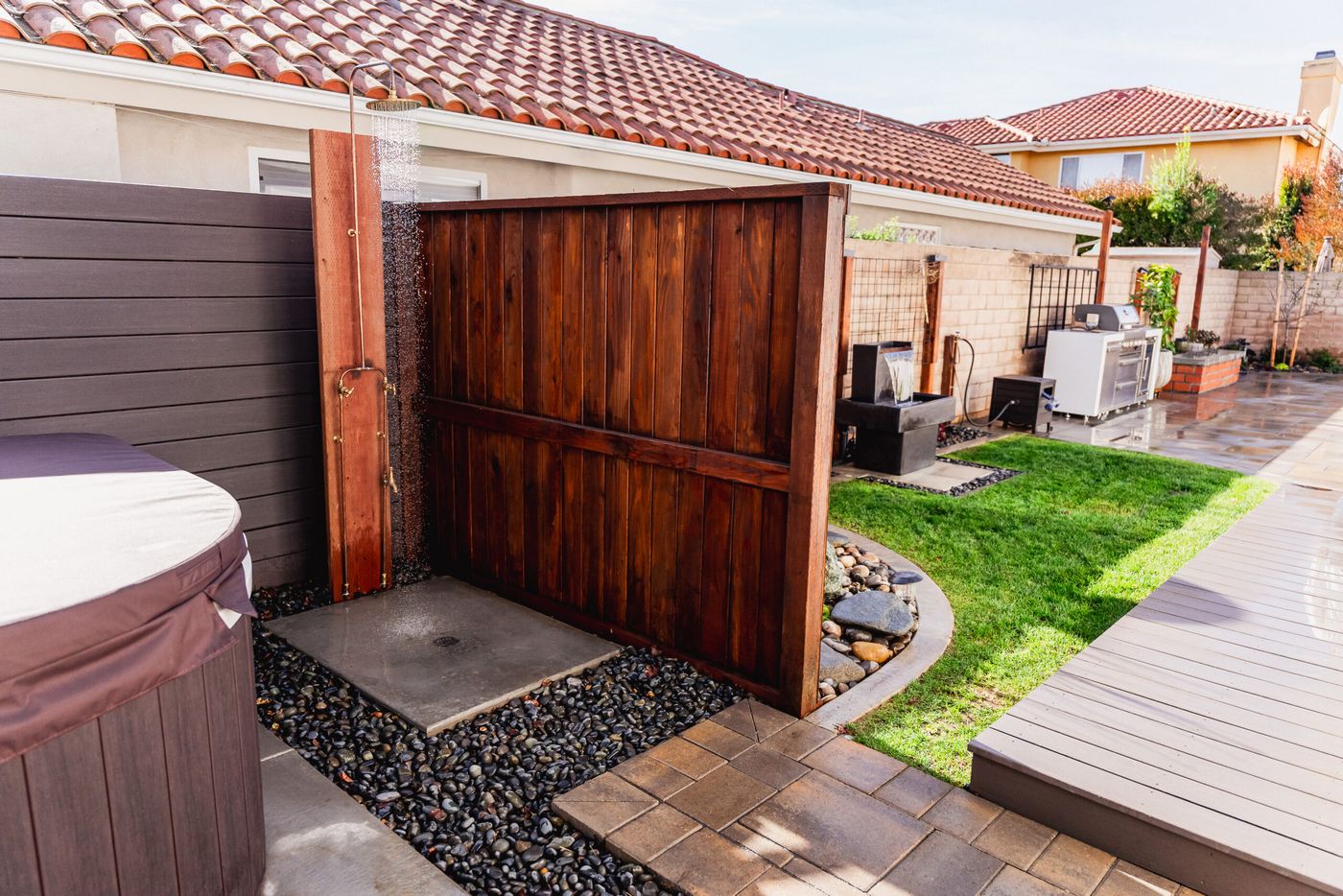 Wood privacy wall with outdoor shower adjacent to landscaped side yard in Santa Maria.
