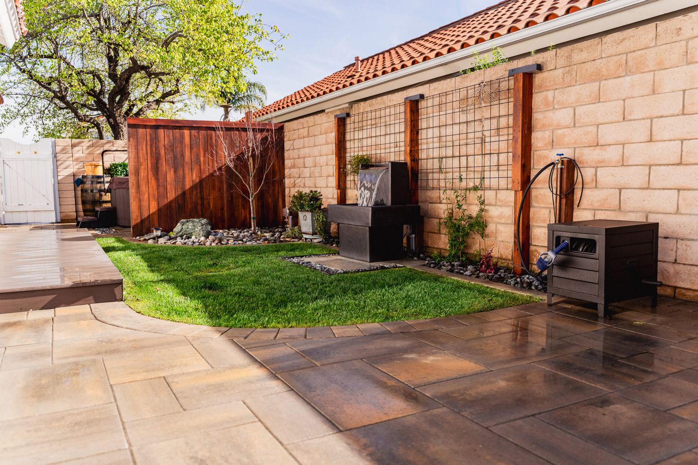 Custom paver patio and curved lawn layout in a Santa Maria side yard landscape renovation.