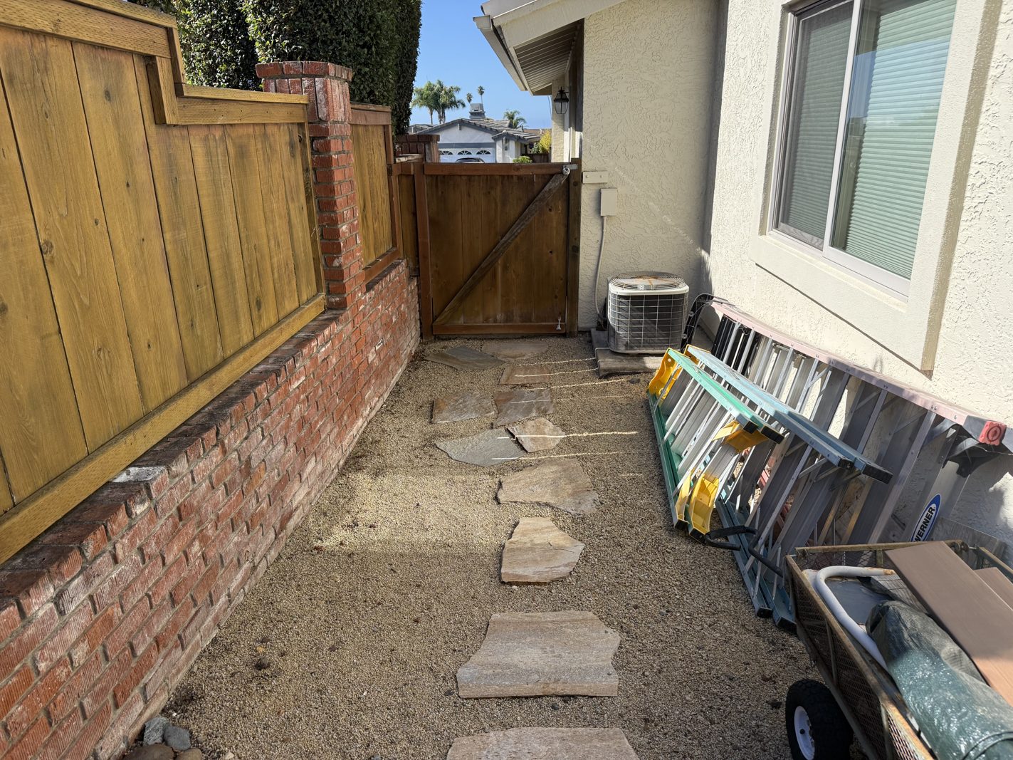 Shell Beach side yard before construction, showing narrow coastal access, existing walls, utilities and surface conditions to measure before design