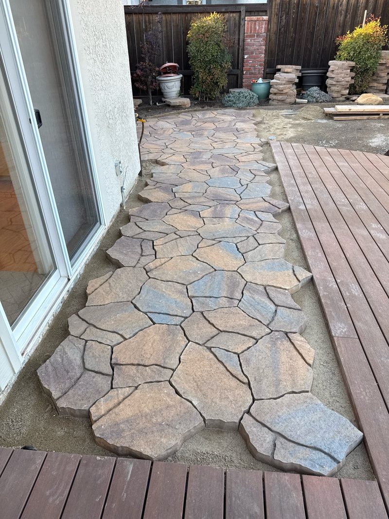 Shell Beach walkway stones dry-laid beside the deck so edges, transitions and drainage can be checked before final installation