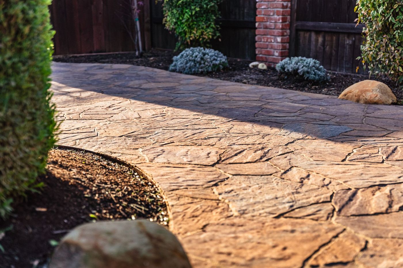 Close-up of stamped concrete walkway with natural flagstone pattern installed in Shell Beach.