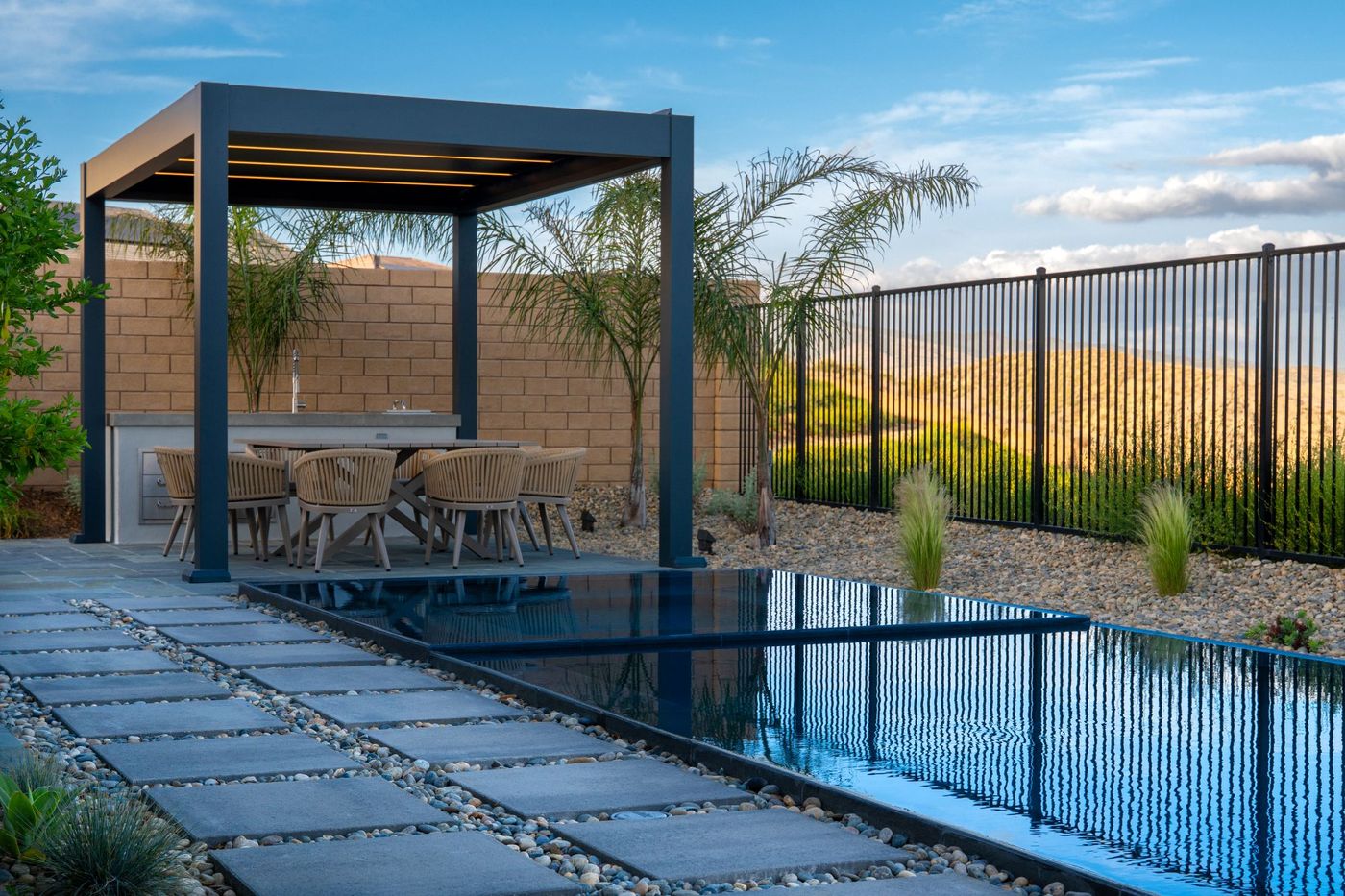 A zero-edge reflecting pool with water running level to the paving beside it