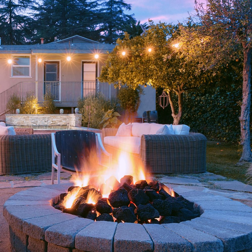 Round stone fire pit installed in irregular flagstone patio with decomposed granite joints.