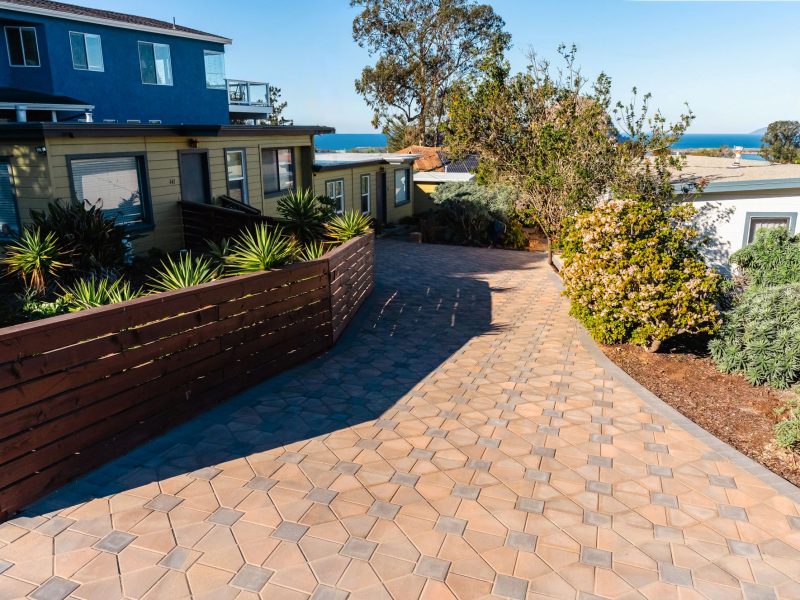 Sloped interlocking paver driveway in Morro Bay with ocean views and surrounding coastal landscaping.