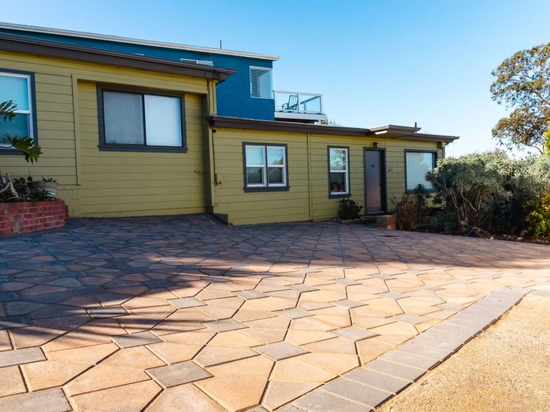 Custom paver driveway in Morro Bay featuring decorative concrete pavers and a modern coastal home backdrop.